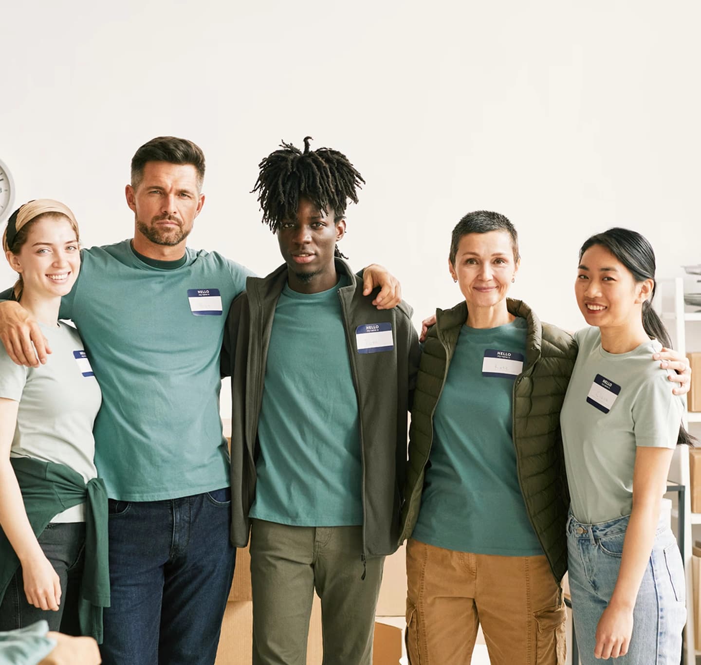 Diverse group of smiling volunteers wearing name tags
